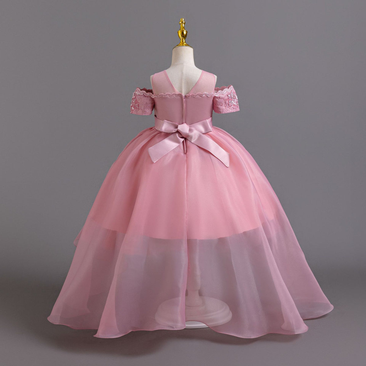 Pink lace girls gown back view with sheer mesh back and satin bow, designed for weddings and parties.