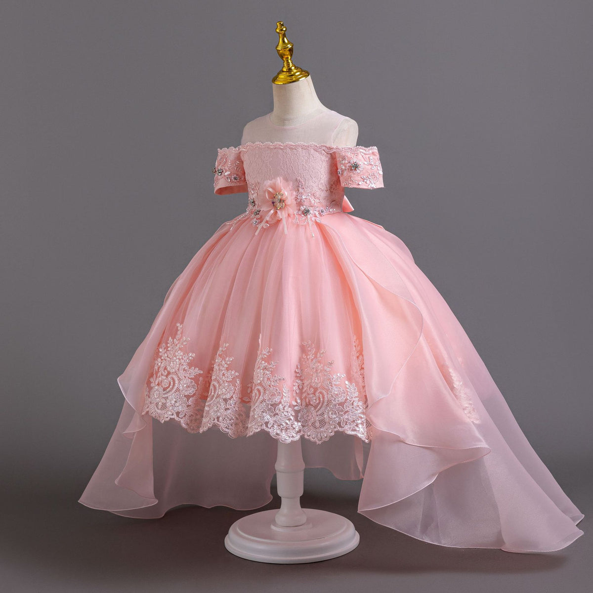 Pink lace girls gown side view with high-low organza train, designed for flower girls and photoshoots.