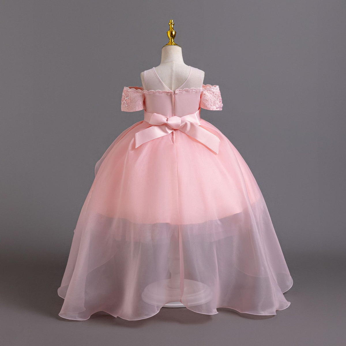 Pink lace girls gown back view with satin bow and full tulle skirt, designed for weddings and parties.