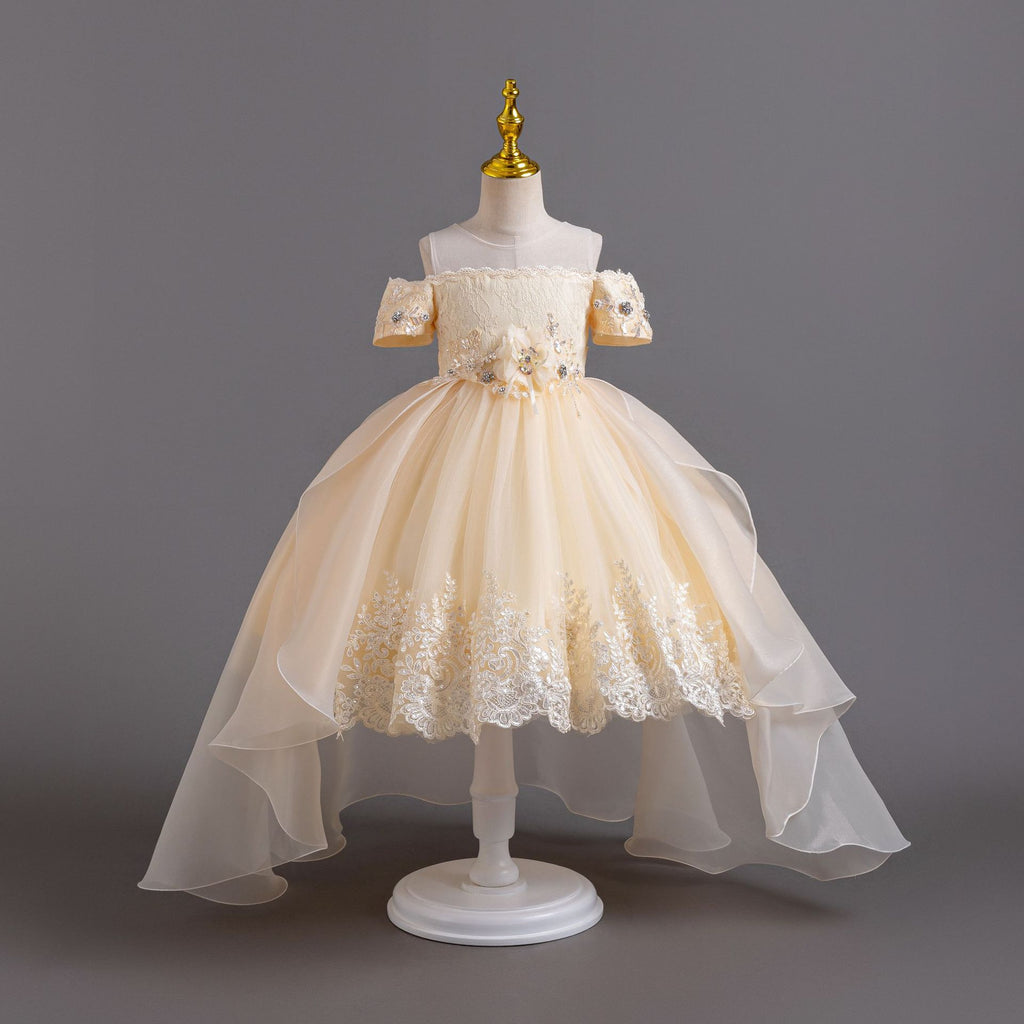 Champagne lace girls gown with off-shoulder beaded sleeves, floral waist and high-low organza train, designed for weddings and pageants.