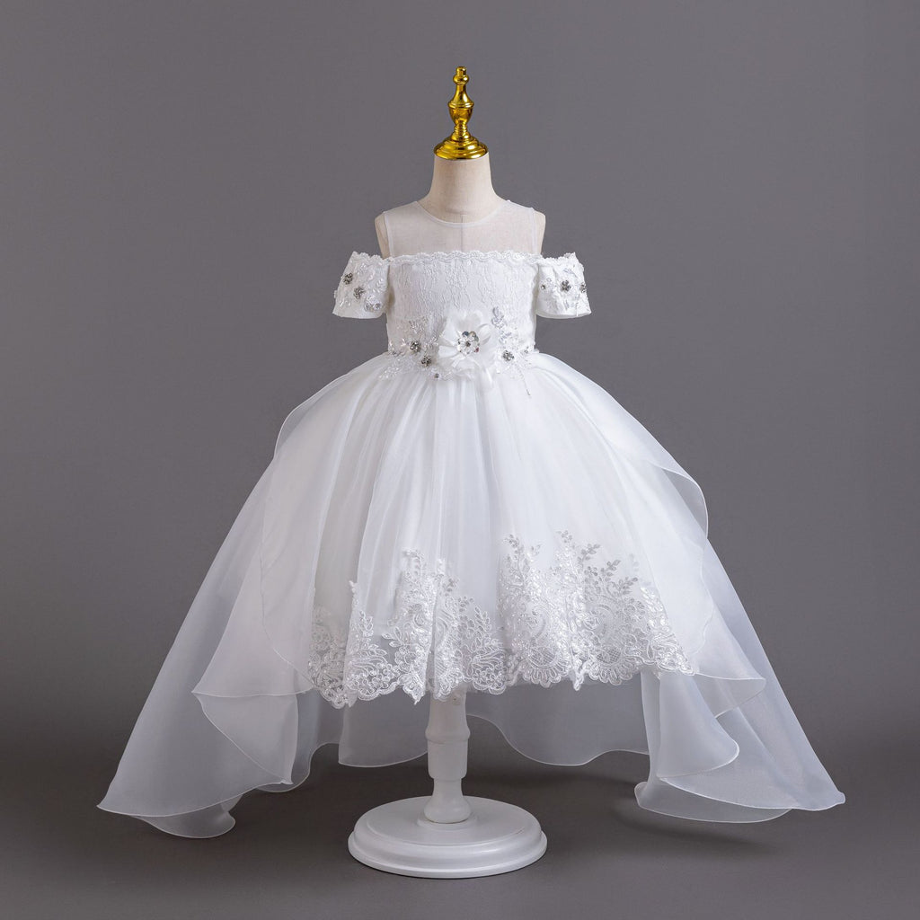 White lace girls gown with off-shoulder beaded sleeves, floral waist and high-low organza train, designed for flower girls at weddings.