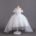White lace girls gown with off-shoulder beaded sleeves, floral waist and high-low organza train, designed for flower girls at weddings.