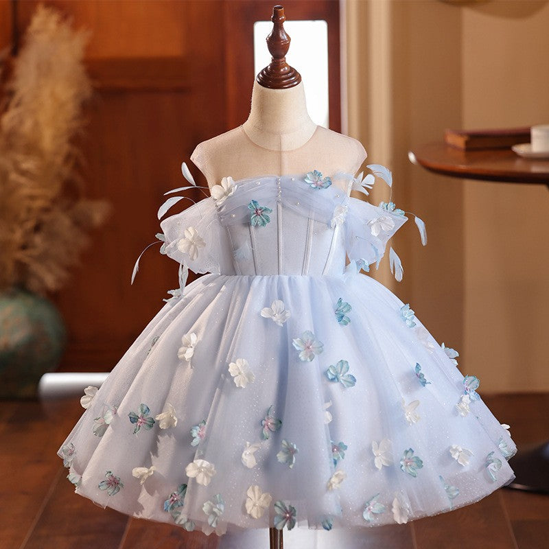Light blue tulle flower girl dress with 3D fabric flowers, feathers and a pearl off-shoulder bodice, front view, for weddings.