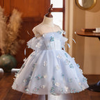 Light blue floral princess dress for girls with puff off-shoulder sleeves and a full tulle skirt, side angle, for a wedding party.