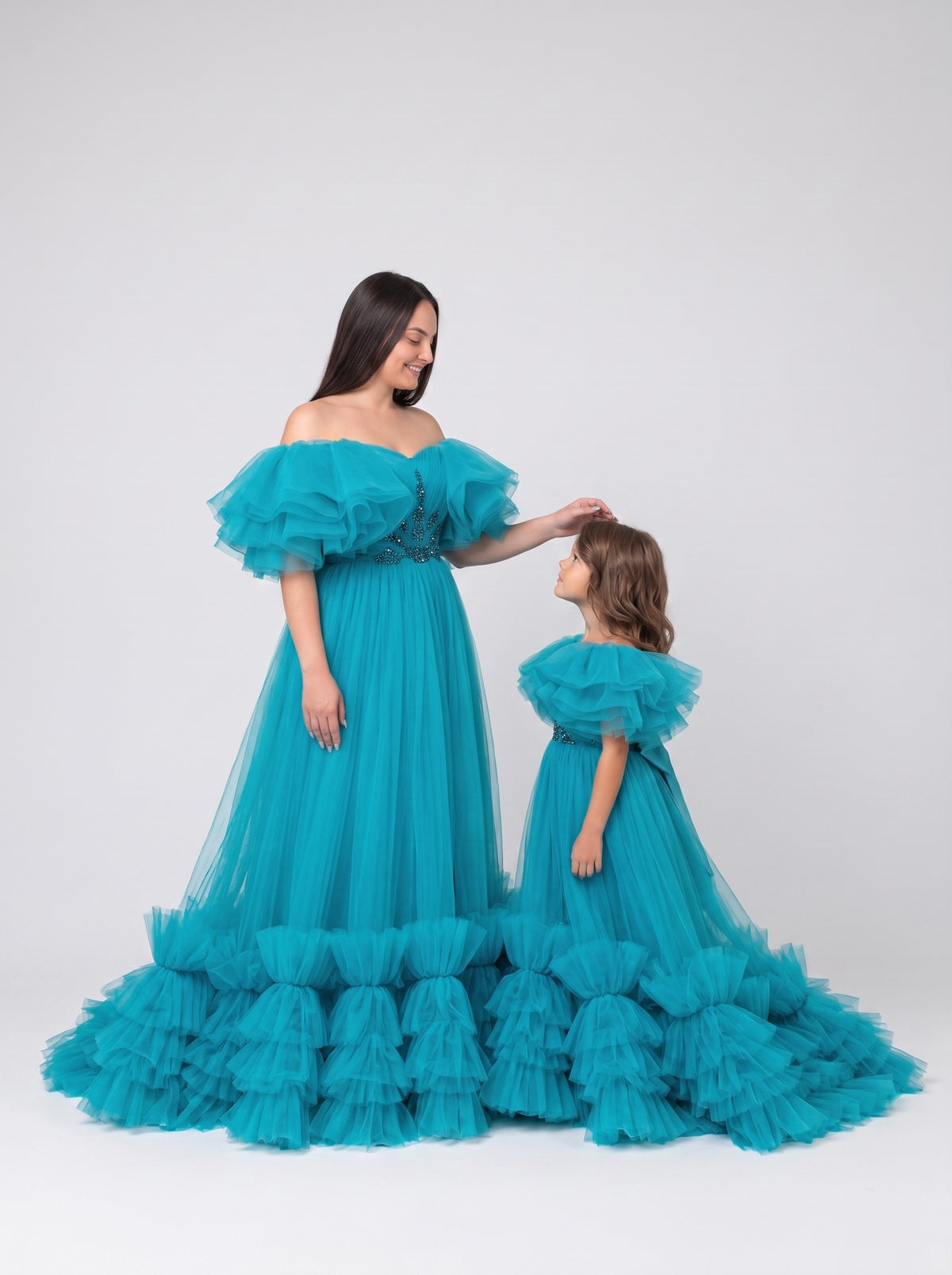 Mommy and daughter matching teal tulle ruffle gowns with train
