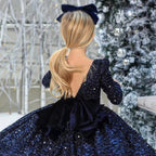 Navy sequin girls dress with long sleeves, open V-back and satin bow, designed for Christmas and holiday parties, view 3