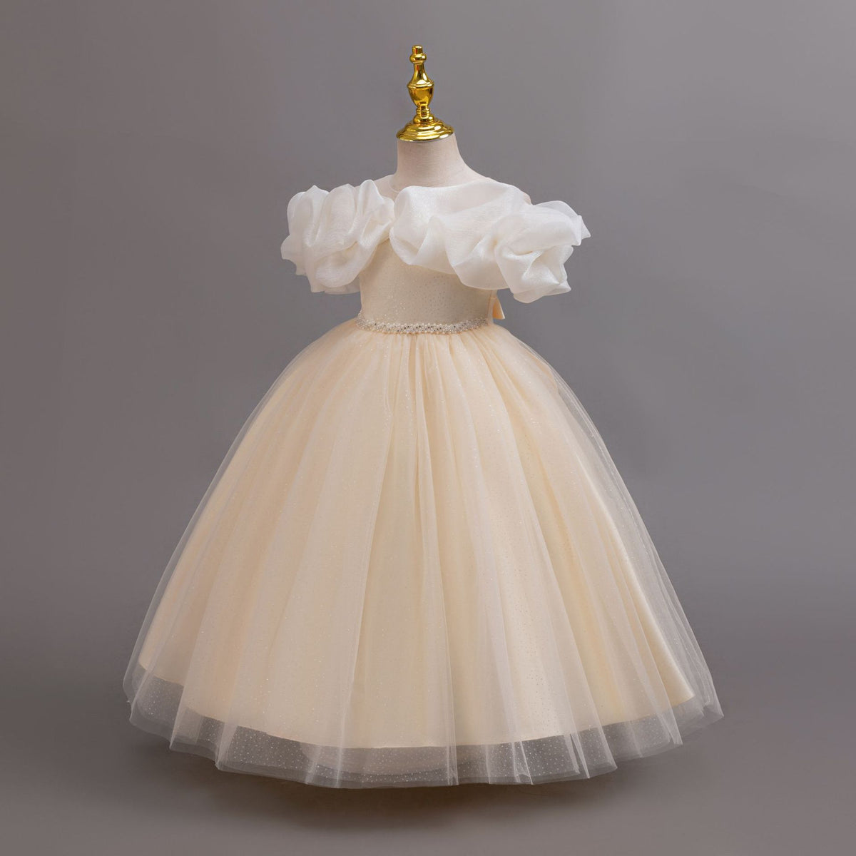 Champagne glitter tulle girls ball gown with an off-shoulder ruffle neckline, pearl beaded waist and back bow, designed for birthdays, weddings and flower girls, view 2