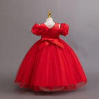 Red glitter tulle girls ball gown with a satin bow and zipper at the back, off-shoulder ruffles and full ball gown skirt, designed for birthdays, weddings and flower girls.