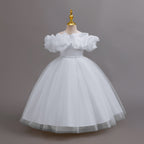 White glitter tulle girls ball gown with an off-shoulder ruffle neckline, pearl beaded waist and back bow, designed for birthdays, weddings and flower girls.