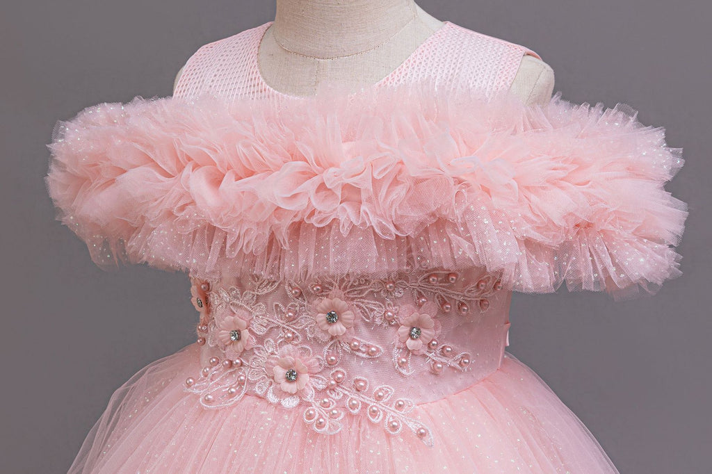 Pink tulle ruffle neckline close-up on a girls ball gown, designed for flower girls and photoshoots.