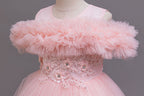 Pink tulle ruffle neckline close-up on a girls ball gown, designed for flower girls and photoshoots.