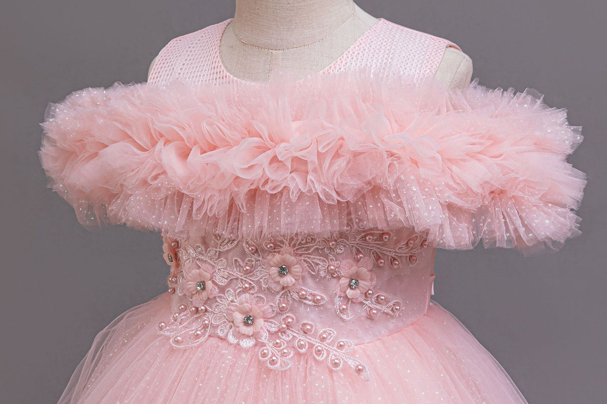 Pink tulle ruffle neckline close-up on a girls ball gown, designed for flower girls and photoshoots.