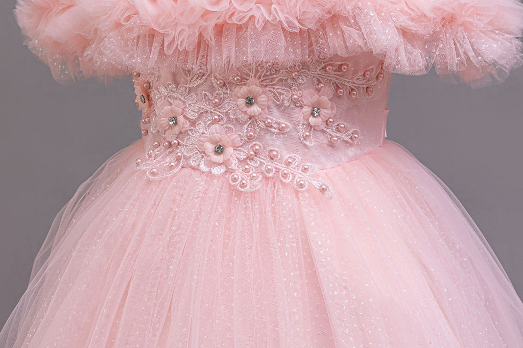 Pink beaded lace appliqué waist close-up on a girls tulle ball gown, designed for weddings.