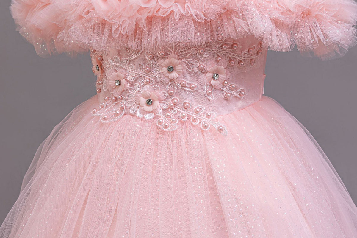 Pink beaded lace appliqué waist close-up on a girls tulle ball gown, designed for weddings.