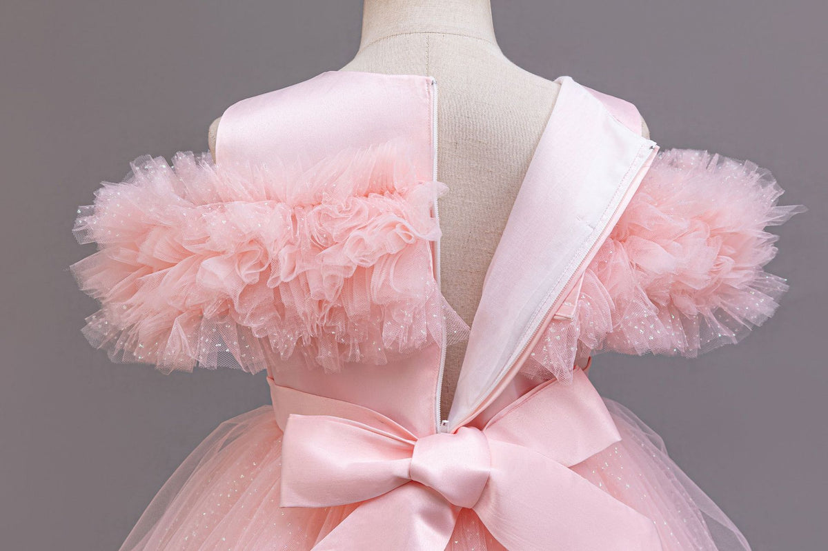 Pink satin back bow and V back close-up on a girls tulle ball gown, designed for flower girls.