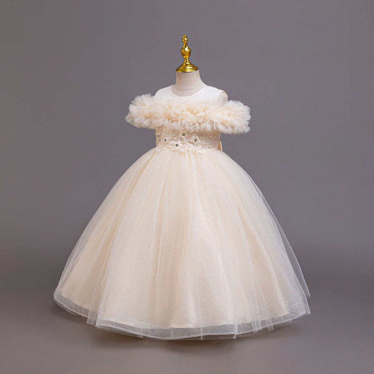 Champagne tulle girls ball gown with off-shoulder ruffles and beaded lace waist, designed for weddings.