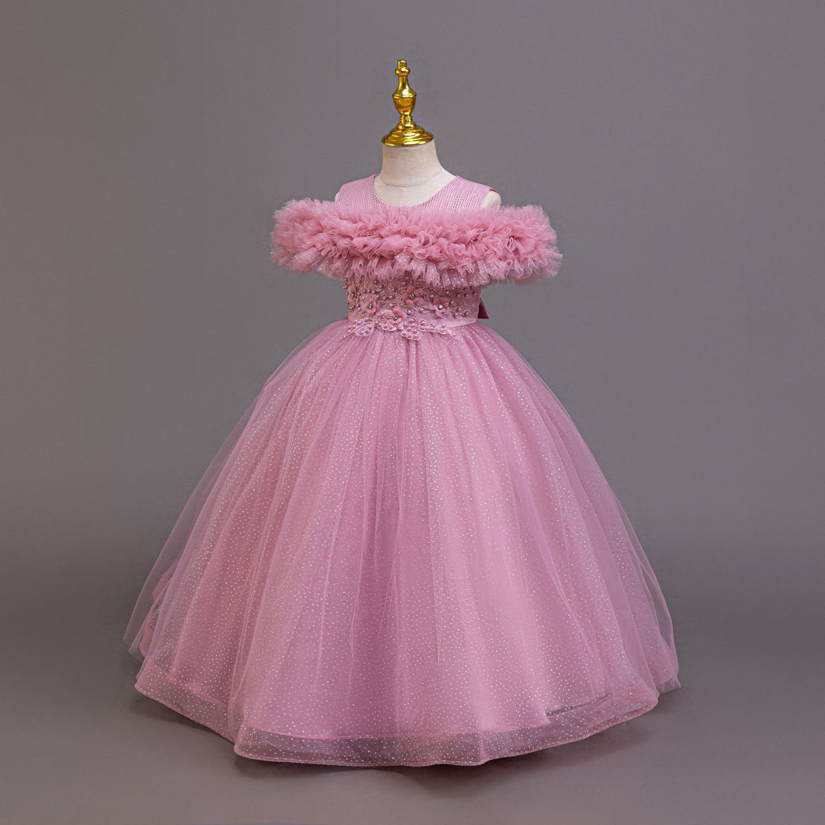 Mauve glitter tulle girls ball gown with ruffled off-shoulder neckline, designed for birthdays and recitals.