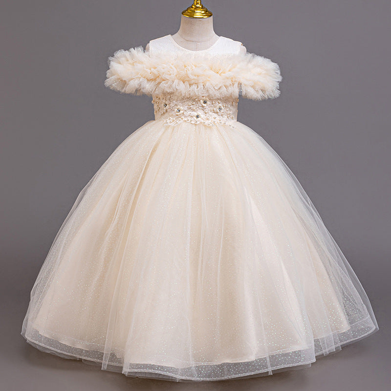 Champagne tulle girls ball gown with off-shoulder ruffle neckline, beaded lace waist and back bow, designed for weddings and flower girls.