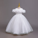 White tulle girls ball gown with off-shoulder ruffle neckline, beaded lace waist and back bow, designed for flower girls and communion.