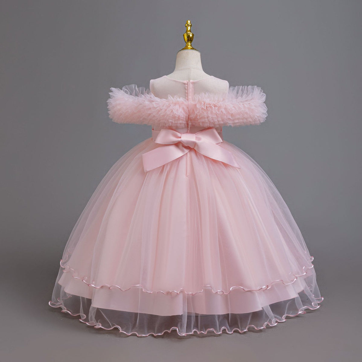 Pink tulle girls ball gown with ruffled off-shoulder neckline, floral appliqué and satin bow back, designed for weddings and parties, view 4