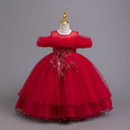 Red tulle girls ball gown with ruffled off-shoulder neckline, floral appliqué and satin bow back, designed for weddings and parties.