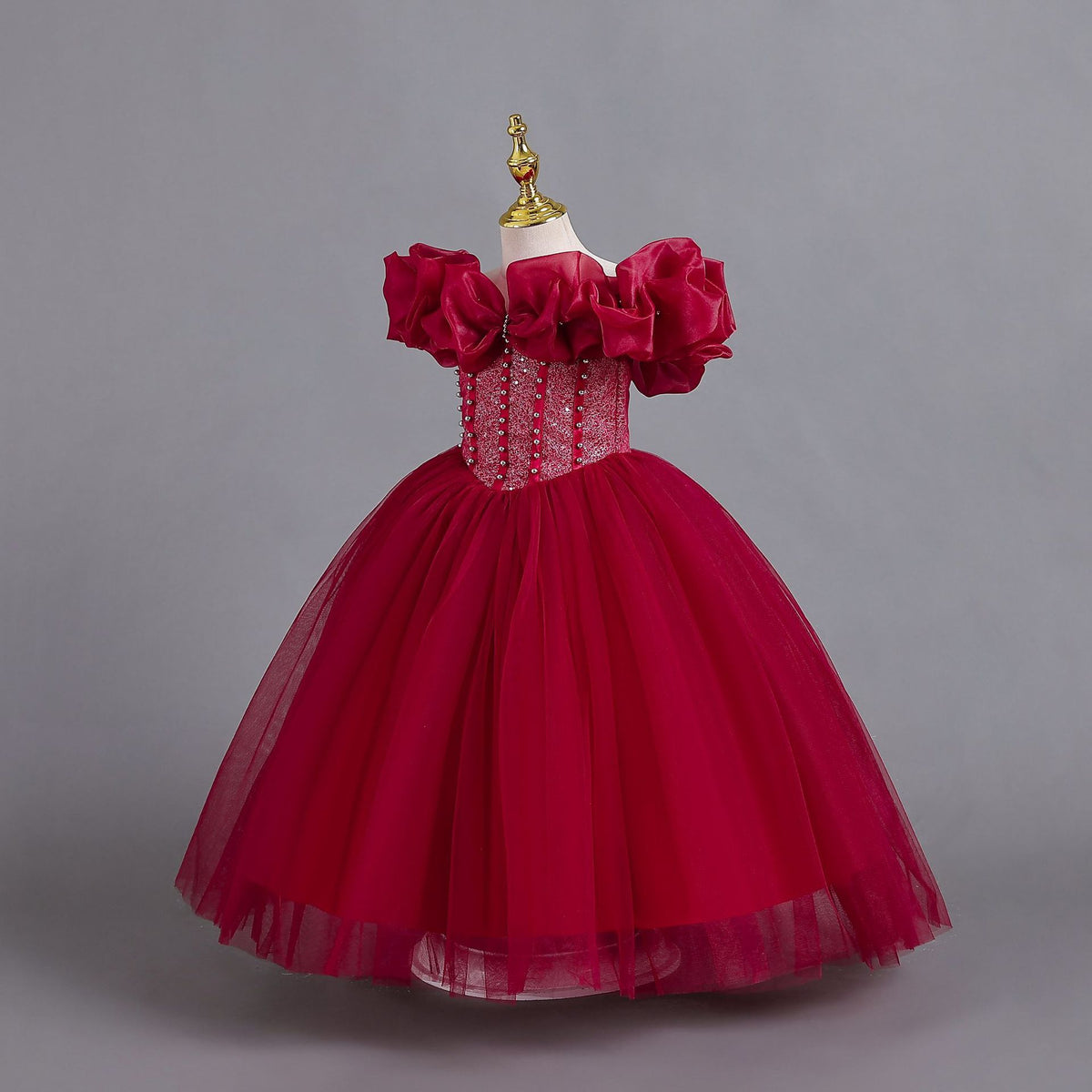 Burgundy tulle girls princess ball gown with off-shoulder organza ruffle sleeves and pearl-beaded bodice, side view, designed for Christmas, weddings and flower girls.
