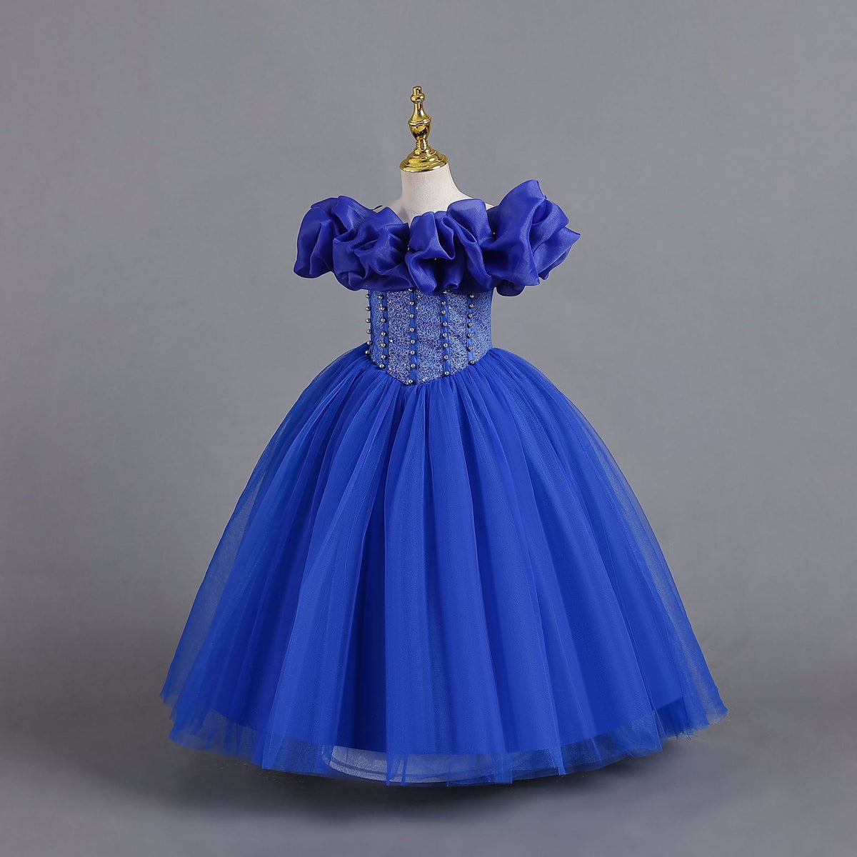 Royal Blue tulle girls princess ball gown with off-shoulder organza ruffle sleeves and pearl-beaded bodice, side view, designed for Christmas, weddings and flower girls.