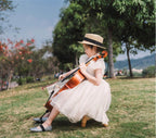 White organza girls dress with puff sleeves and layered skirt, designed for weddings and birthdays.
