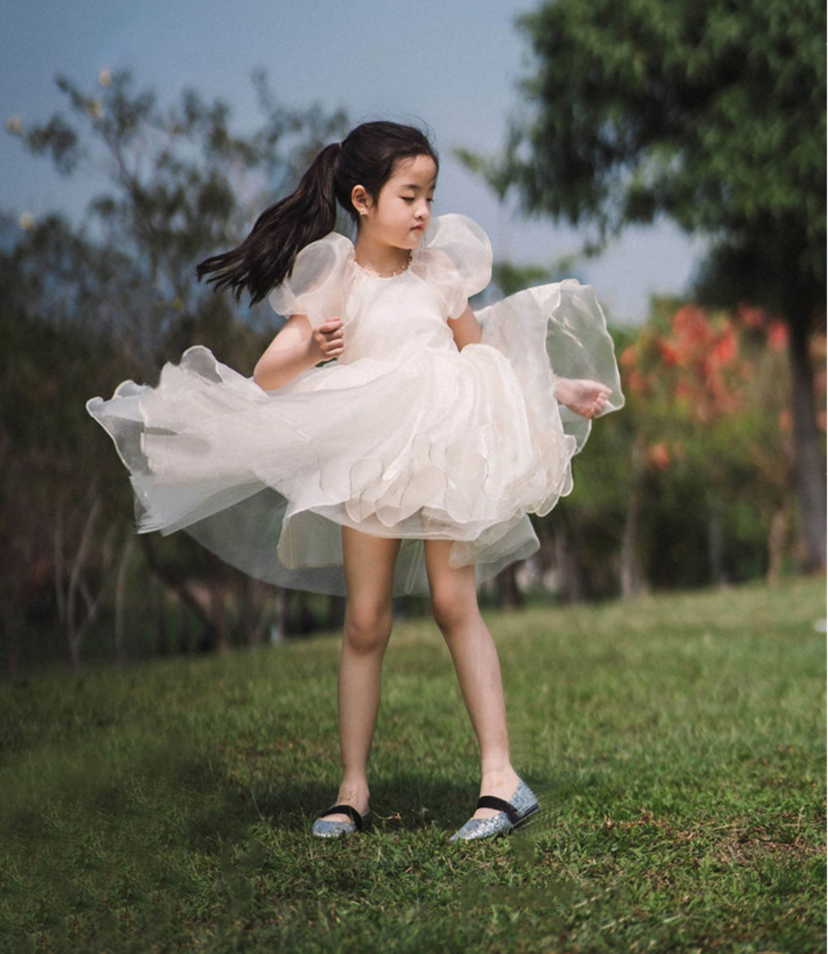 White organza girls dress with V back and puff sleeves, designed for flower girls.
