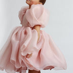 Blush pink organza girls dress with layered bubble skirt and puff sleeves, designed for flower girls.