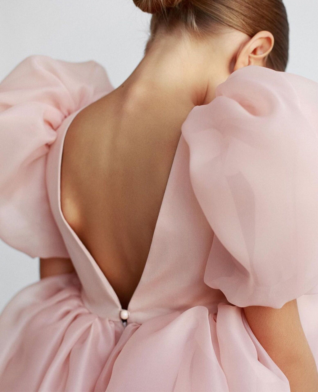 Blush pink organza girls dress with sheer puff sleeves, designed for parties and recitals.