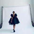 White organza girls dress with puff sleeves and knee-length skirt, designed for outdoor photoshoots.