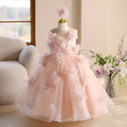 Pink tulle girls party dresses styled with a matching flower hair piece, front view 2, for a wedding or birthday.