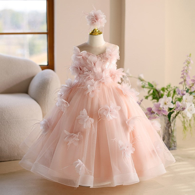 Pink tulle girls party dresses styled with a matching flower hair piece, front view 2, for a wedding or birthday.