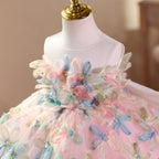 Close-up of the 3D floral applique with beaded centres on the bodice of the pink girls formal dress.