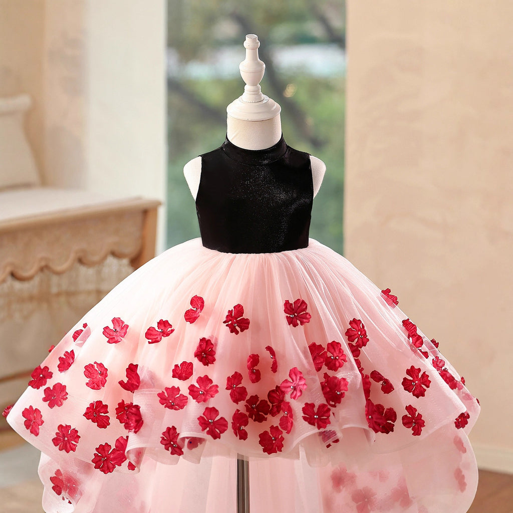 Close-up of the 3D red flower appliques and tiered tulle ruffle on the pink and black birthday girls dresses.