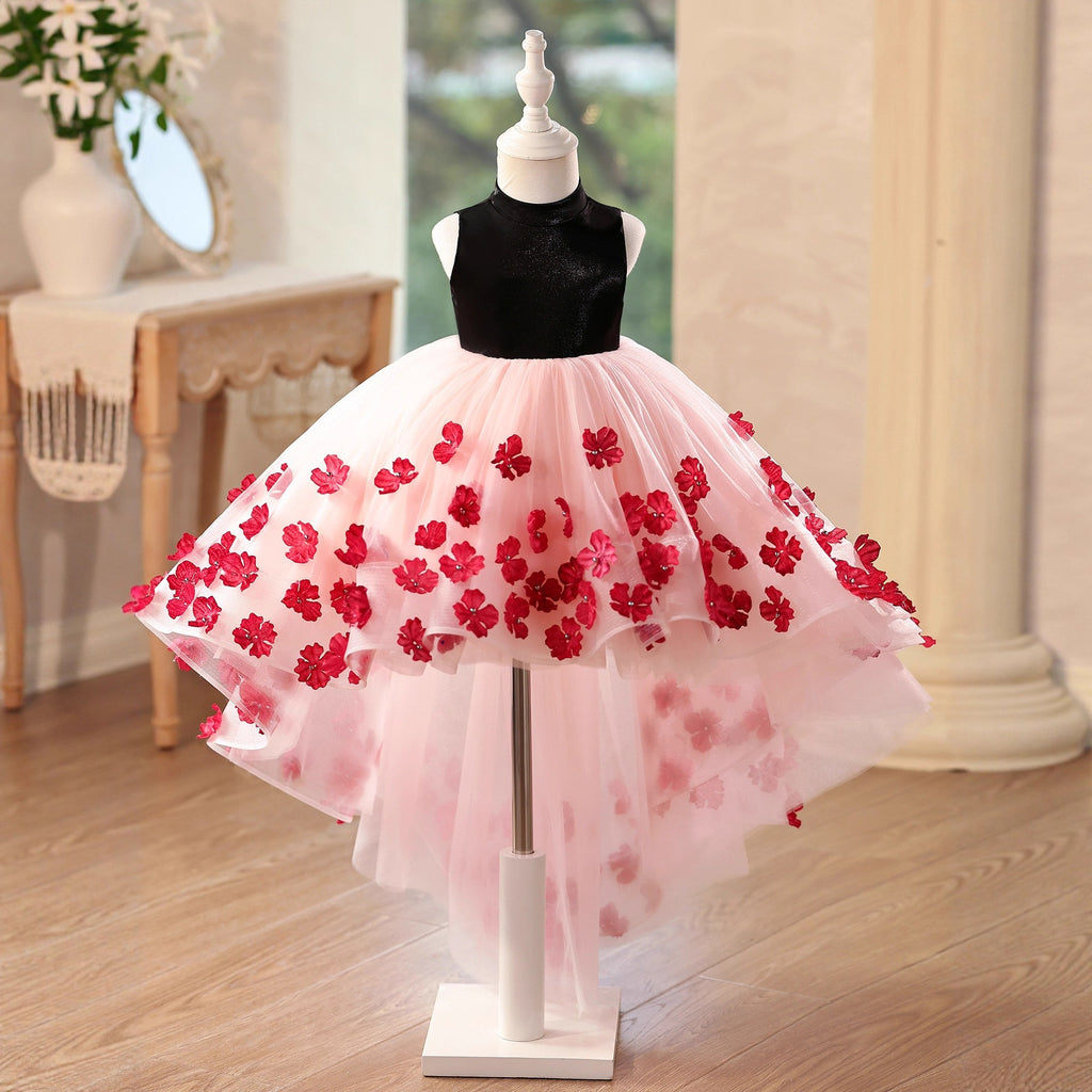 Pink and black tulle flower girl dresses with a black velvet mock neck bodice and 3D red flower appliques on a high-low skirt, front view, for weddings.
