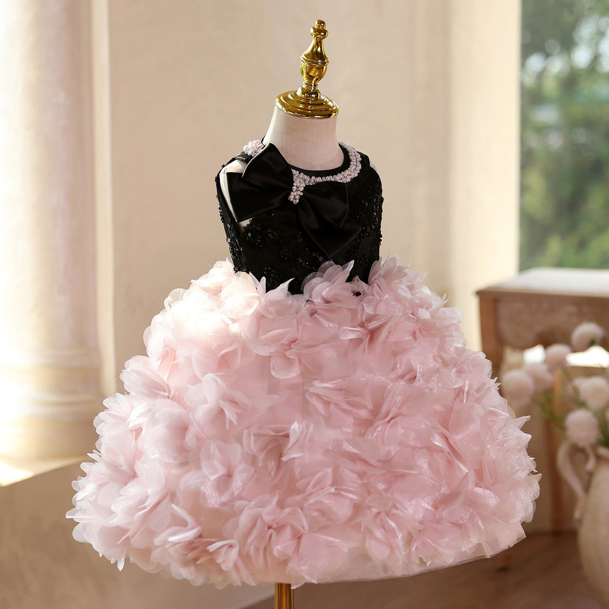 Pink and black sequin girls party dress with pearl pendant neckline and layered petal skirt, designed for parties and performances.