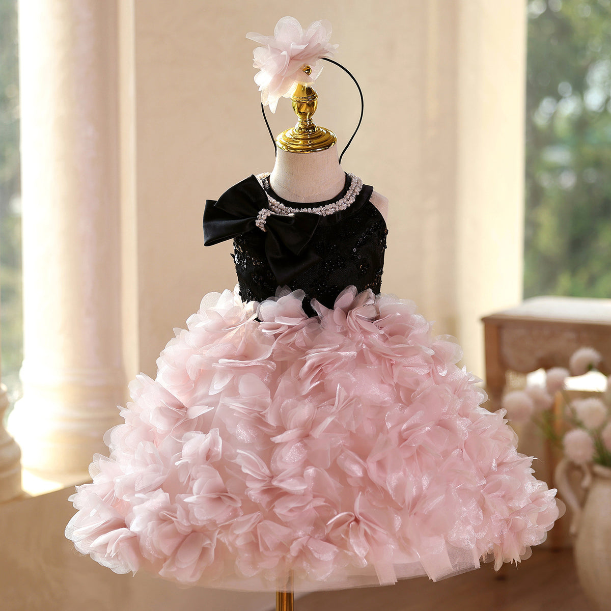 Pink and black sequin girls party dress with pearl neckline, satin bow and petal skirt, designed for birthdays and pageants.