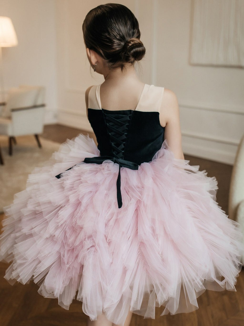Pink and black tulle girls tutu dress with a corset lace-up back and a layered ruffled skirt, designed for birthday parties.