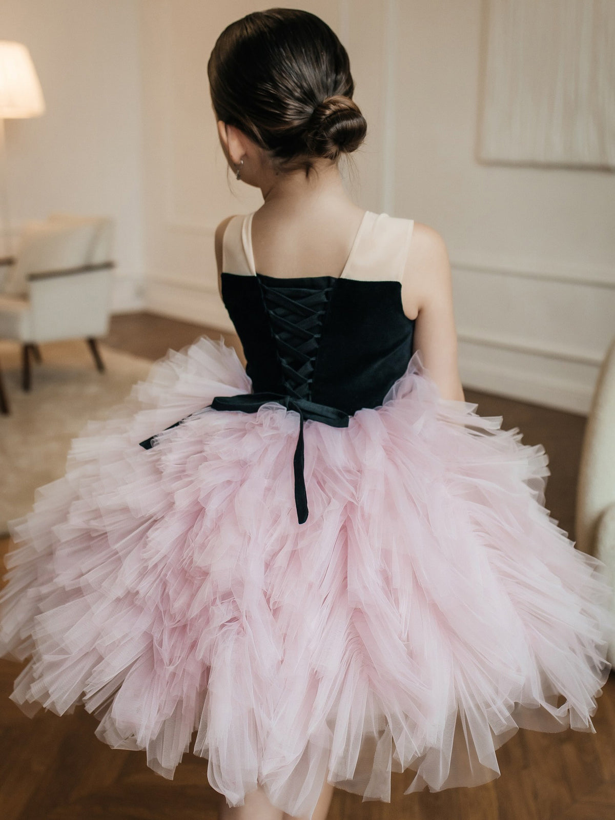 Pink and black tulle girls tutu dress with a corset lace-up back and a layered ruffled skirt, designed for birthday parties.