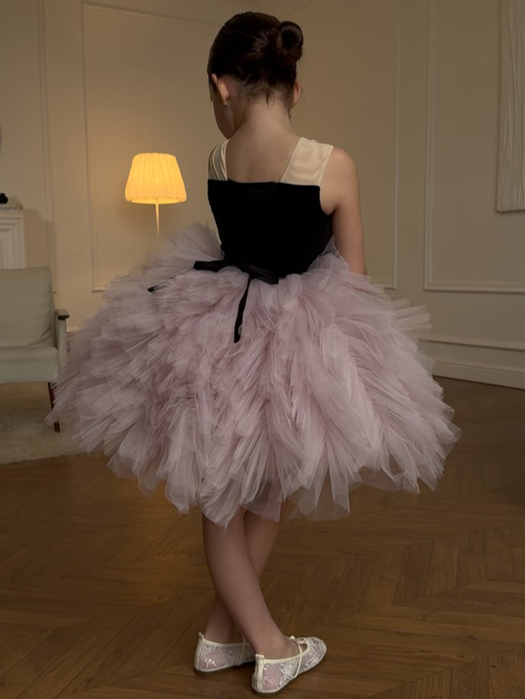Pink and black tulle girls tutu dress with a lace-up back and ribbon tails, designed for birthday parties and photoshoots.