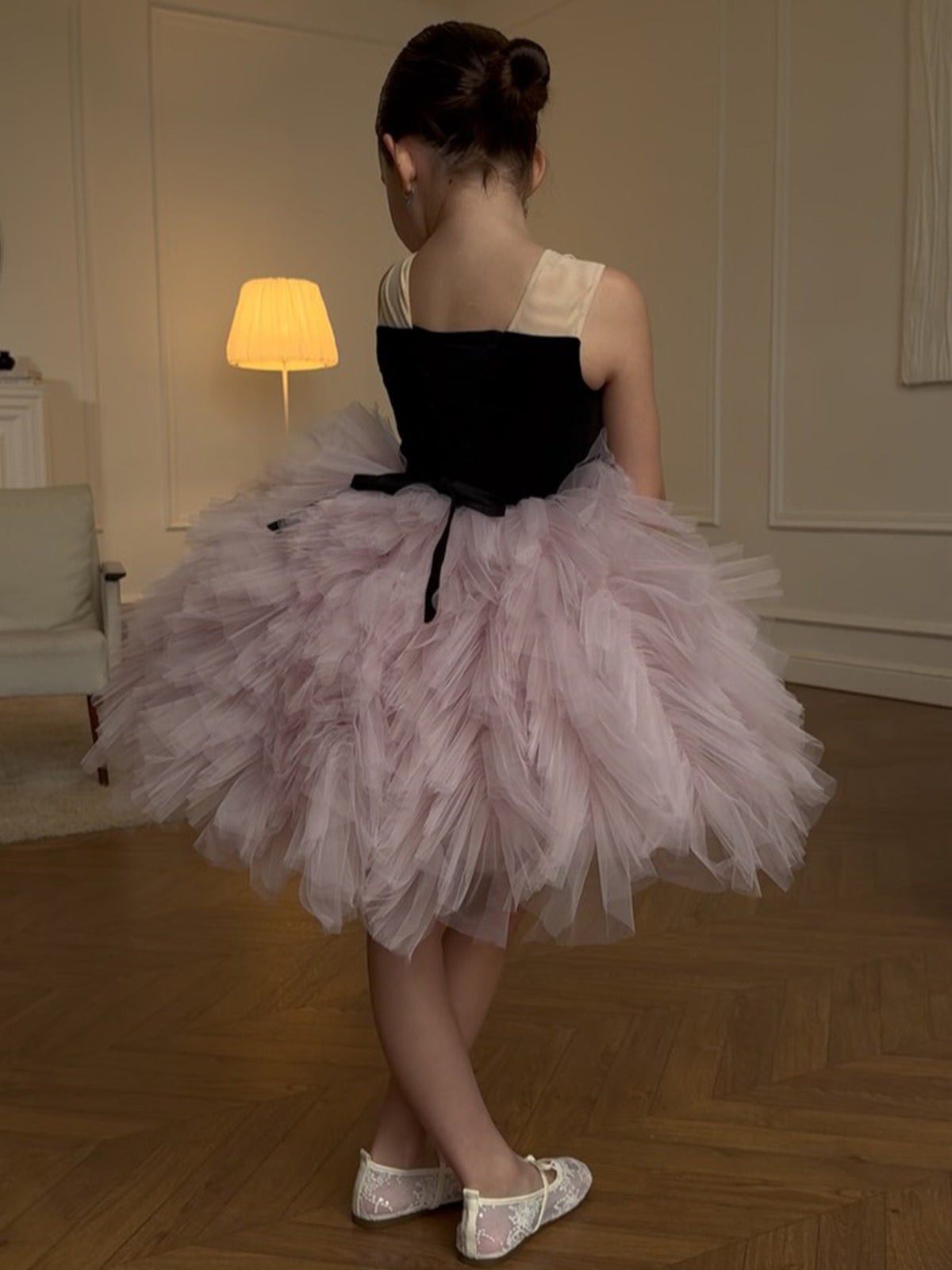 Pink and black tulle girls tutu dress with a lace-up back and ribbon tails, designed for birthday parties and photoshoots.