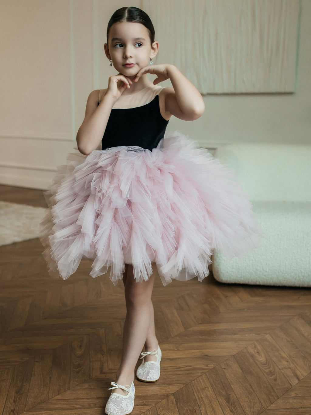 Pink and black tulle girls tutu dress with a black bodice, mesh shoulder straps and a ruffled skirt, designed for birthday parties.