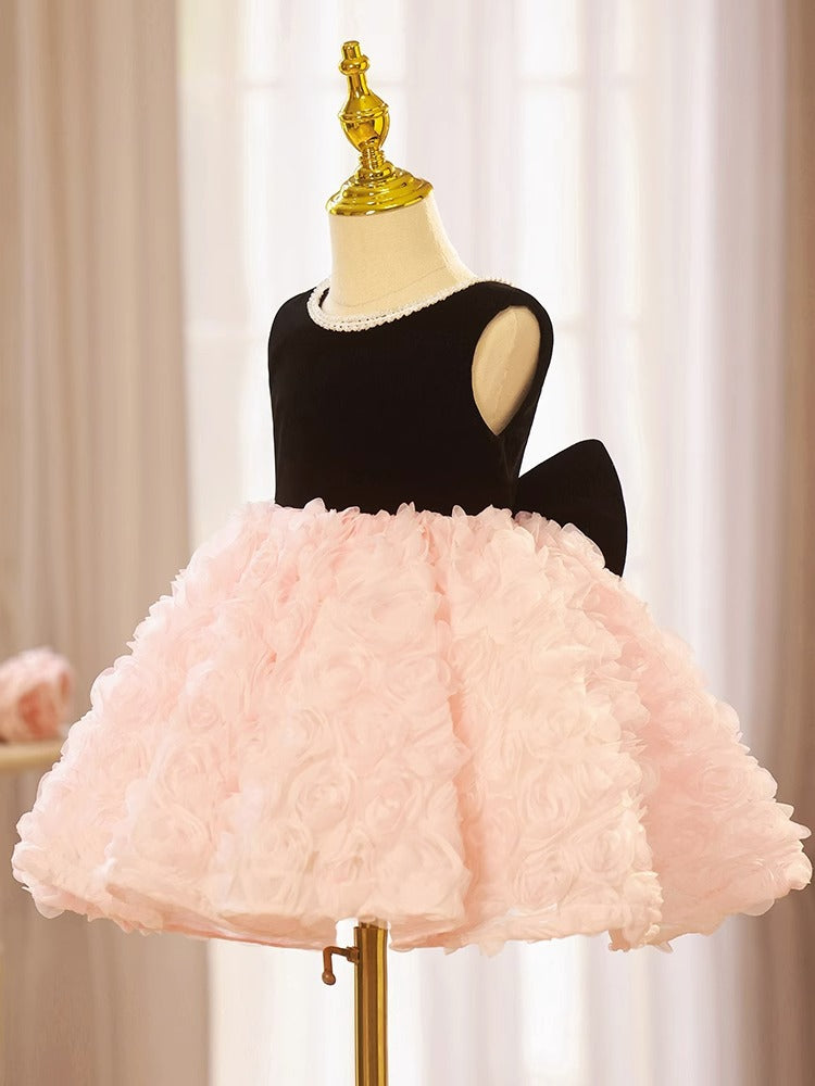 Pink and black velvet and tulle girls party dress with a pearl-trimmed neckline, 3D rosette skirt and big back bow, designed for birthdays and weddings, view 2