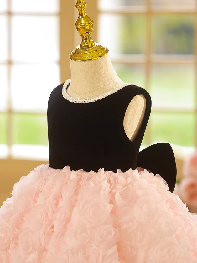 Pink and black velvet and tulle girls party dress with a pearl-trimmed neckline, 3D rosette skirt and big back bow, designed for birthdays and weddings, view 3