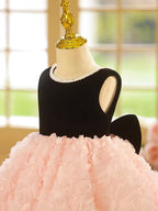 Pink and black velvet and tulle girls party dress with a pearl-trimmed neckline, 3D rosette skirt and big back bow, designed for birthdays and weddings, view 3