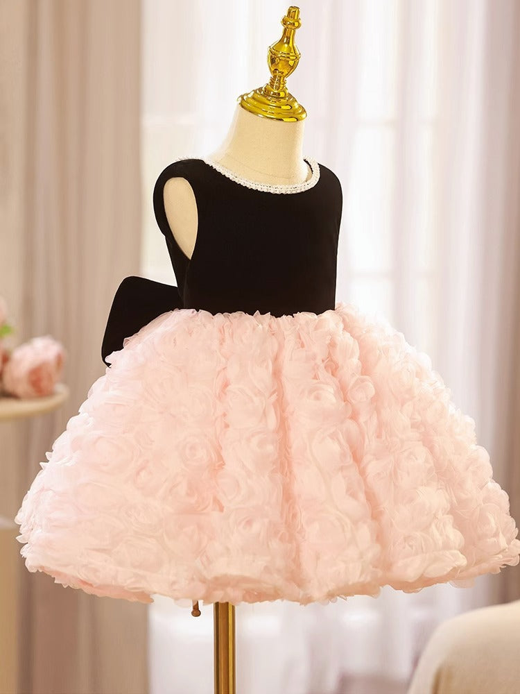 Pink and black velvet and tulle girls party dress with a pearl-trimmed neckline, 3D rosette skirt and big back bow, designed for birthdays and weddings, view 4
