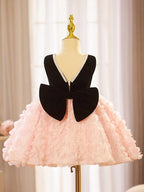 Pink and black velvet and tulle girls party dress with a pearl-trimmed neckline, 3D rosette skirt and big back bow, designed for birthdays and weddings, view 5