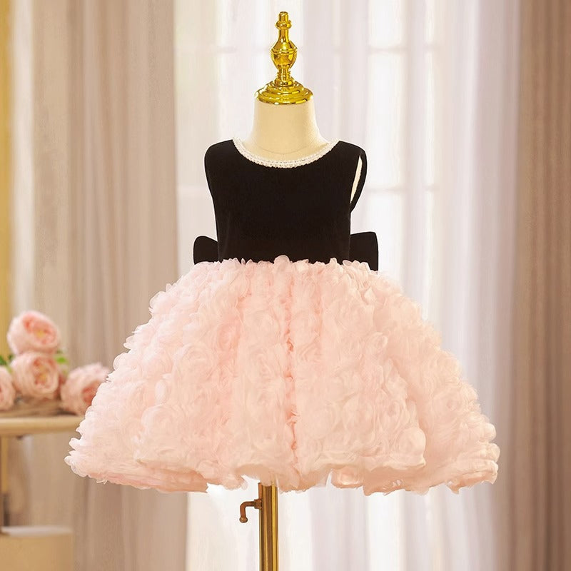 Pink and black velvet and tulle girls party dress with a pearl-trimmed neckline, 3D rosette skirt and big back bow, designed for birthdays and weddings, view 6
